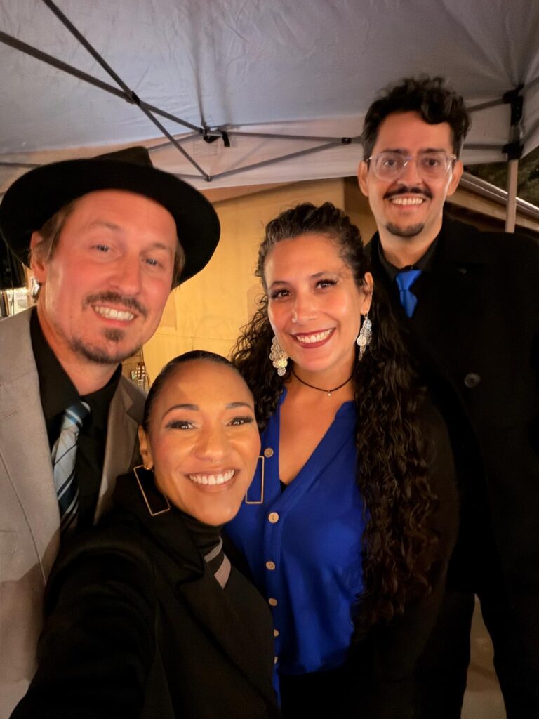 Four Acoustic Quartet performers together in coordinated black and blue clothing